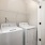 lighted laundry closet with side-by-side washer/dryer units