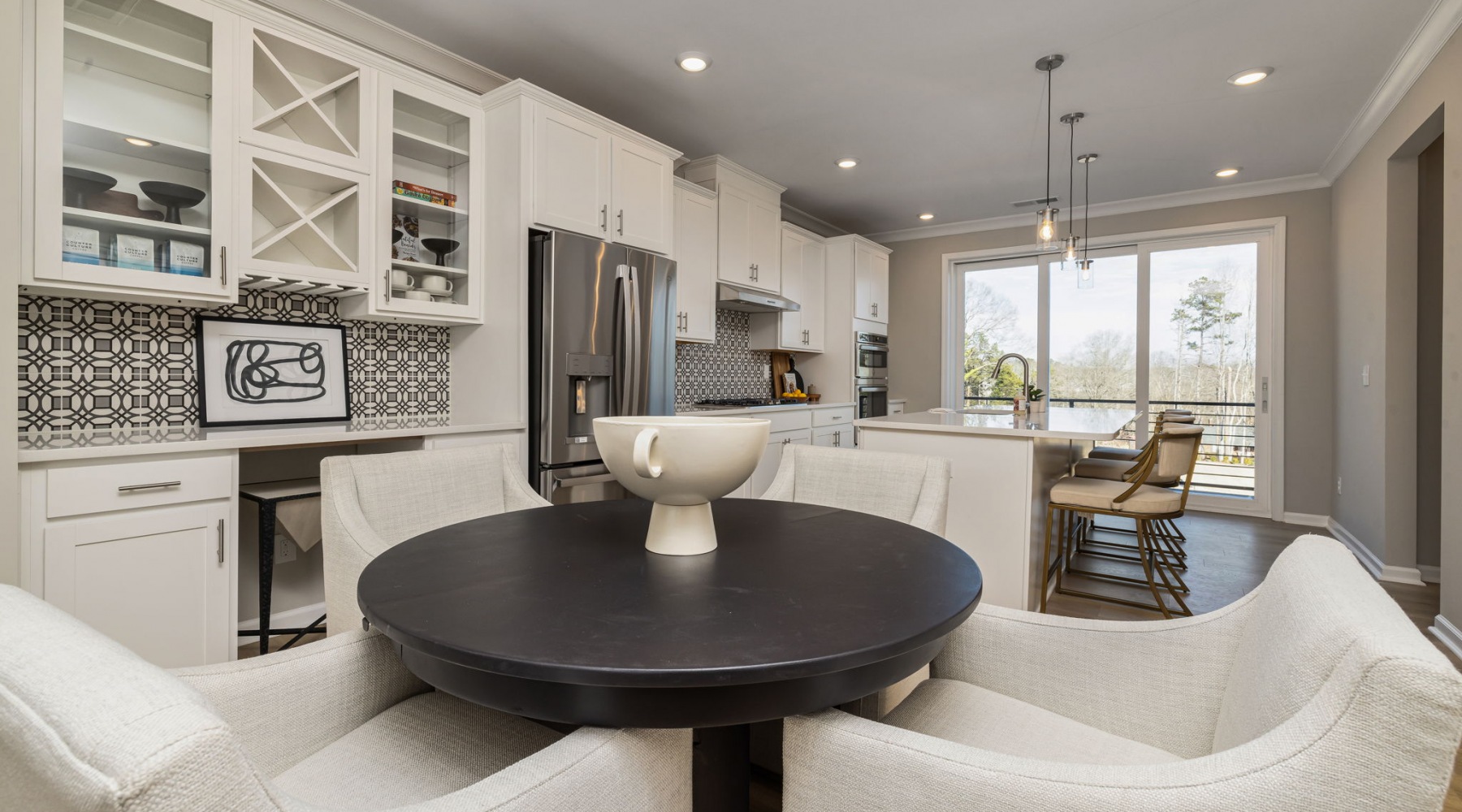 Kitchen space oversized windows surround dining area