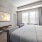 light fixture in large, carpeted bedroom
