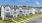 Exterior image of 3-story townhomes with landscaping and sidewalks