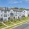 Exterior image of 3-story townhomes with landscaping and sidewalks